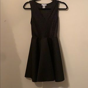 Black cocktail dress. Lace at the top.